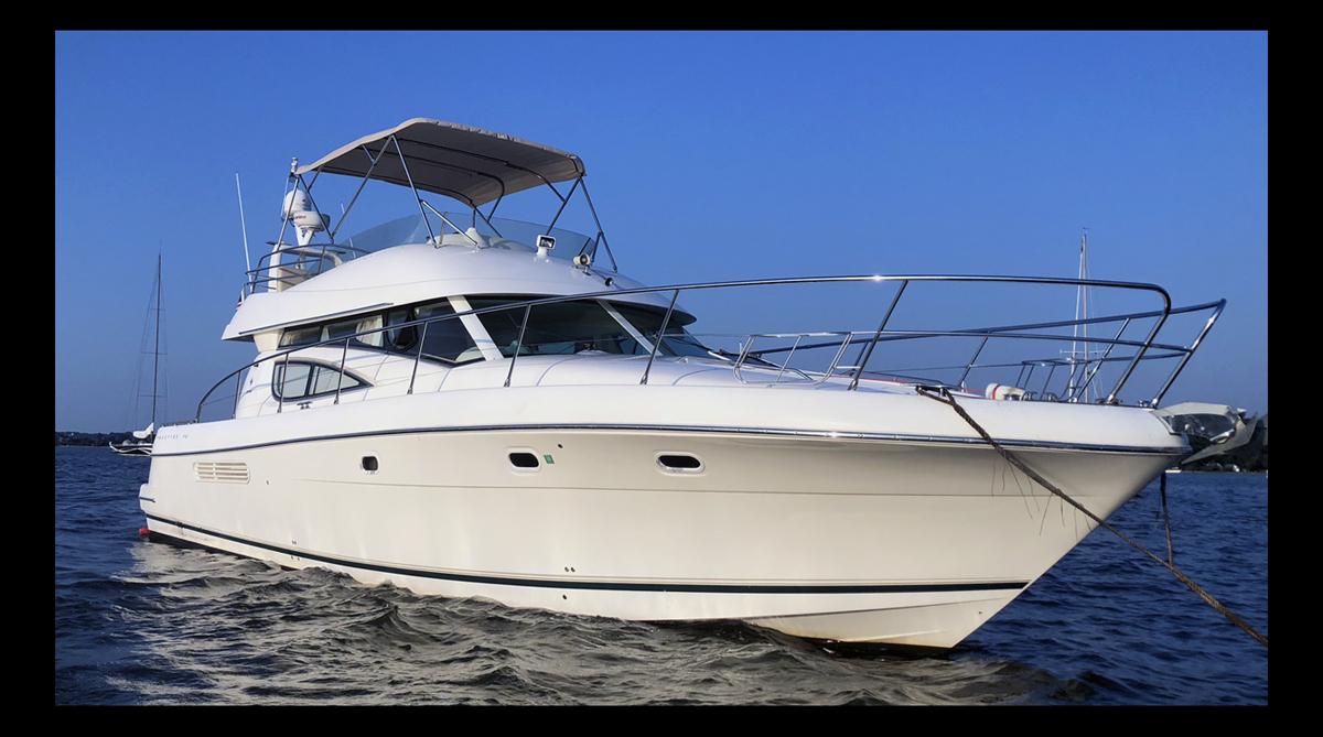 Jeanneau Prestige 46 2007 Jeanneau Prestige 46 yacht on calm water, clear blue sky background.