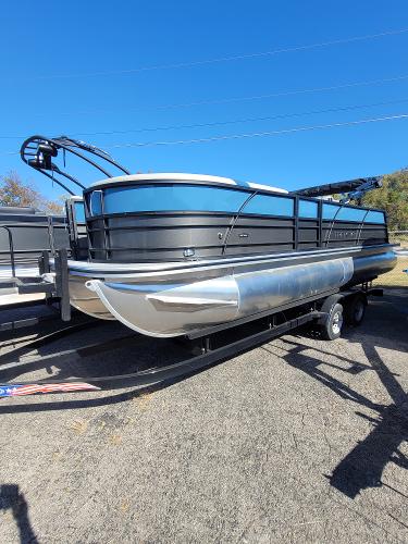 Trifecta 24ULLET275 2025 Trifecta 24ULLET275 pontoon boat on trailer, sleek design, parked outdoors.