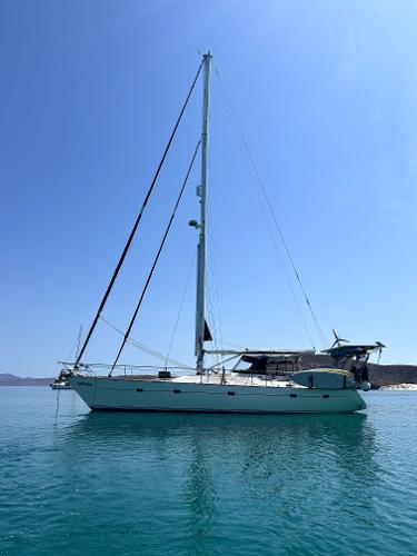 Custom Ancosta Dubois Sailboat "Ancosta Dubois" 1988 model on calm blue water under clear sky.