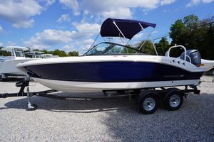 Chaparral 21 SSi OB 2026 Chaparral 21 SSi OB boat on trailer, blue and white design, parked outdoors.