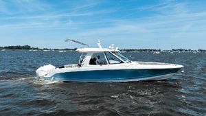 Boston Whaler 38 Realm 2020 Boston Whaler 38 Realm cruising on open water under a clear blue sky.