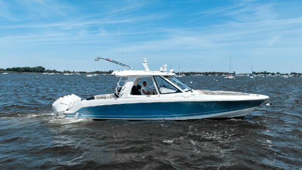 Boston Whaler 38 Realm 2020 Boston Whaler 38 Realm cruising on open water under a clear blue sky.