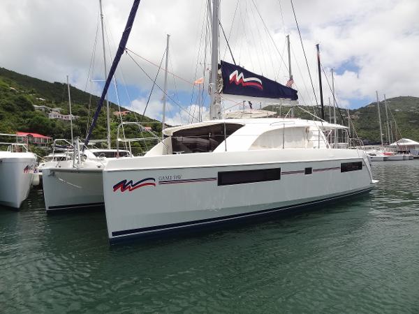 Leopard 40 2020 Leopard 40 catamaran docked in a marina with scenic hillside background.