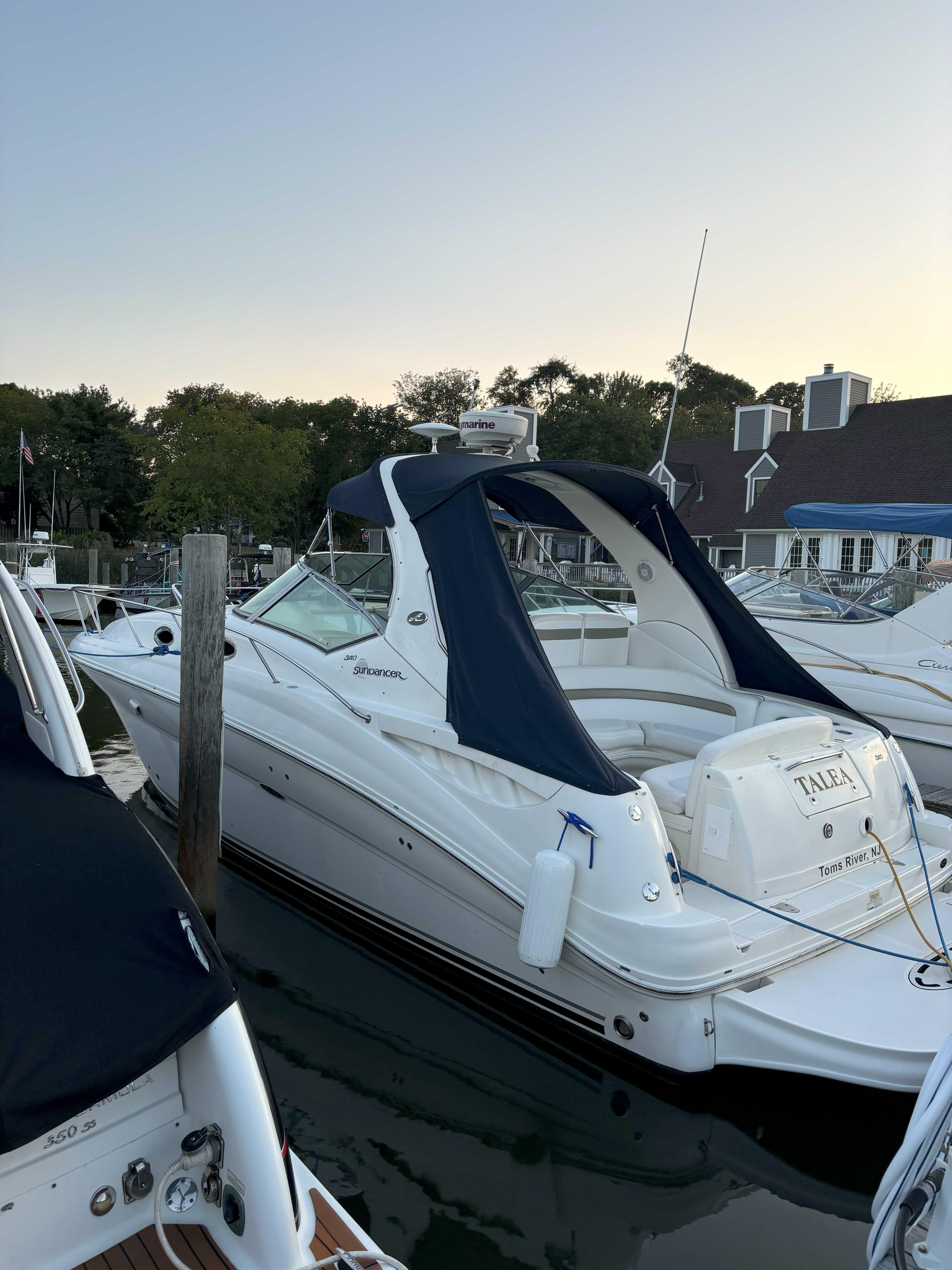 Sea Ray 320 Sundancer 2007 Sea Ray 320 Sundancer yacht docked at marina, featuring sleek design and blue canopy.