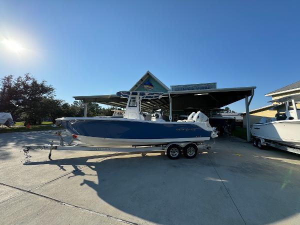 NauticStar 252 Legacy 2025 NauticStar 252 Legacy boat on trailer under sunny sky.