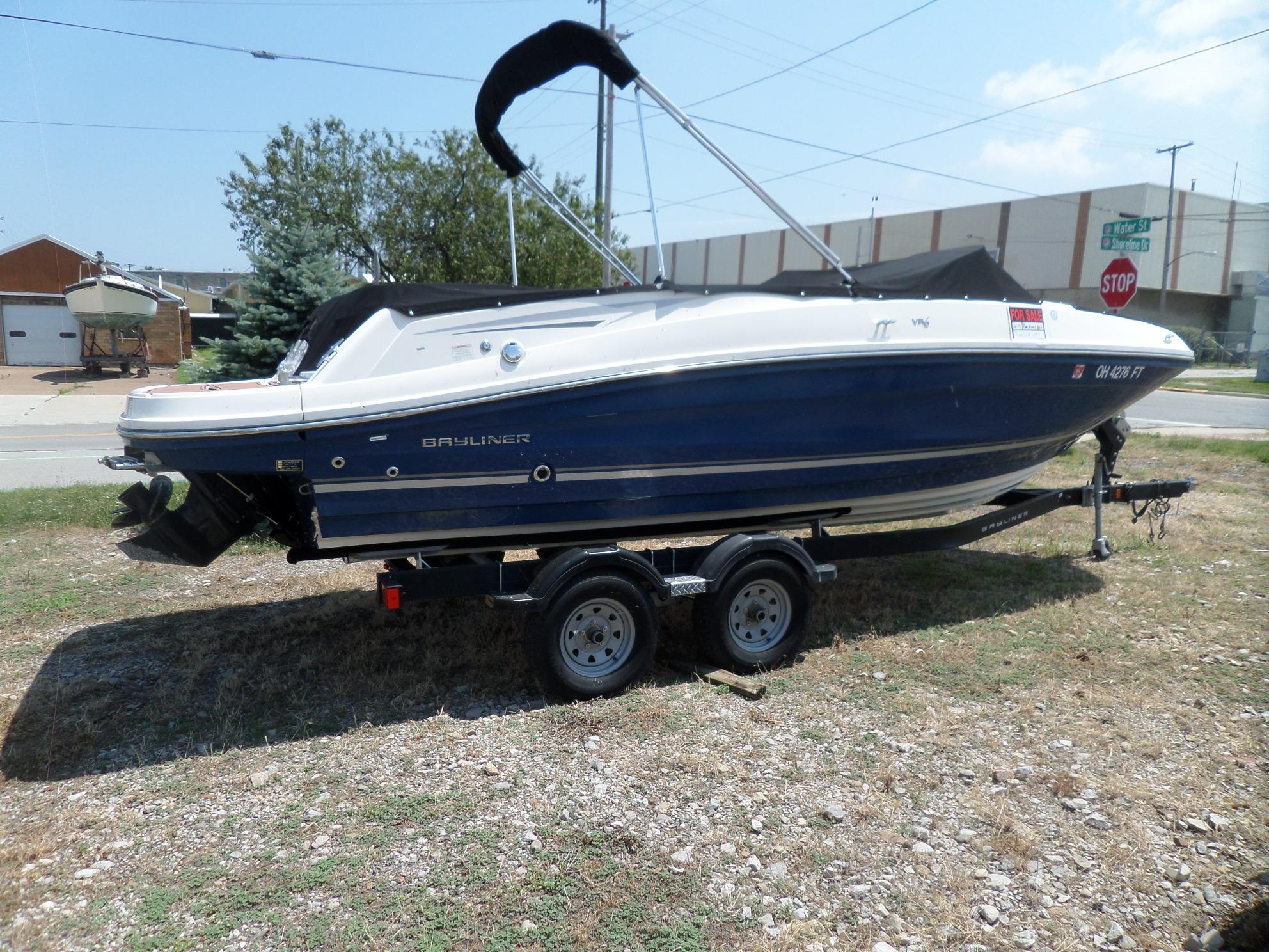 Bayliner VR6 Bowrider I/O 2017 Bayliner VR6 Bowrider I/O on trailer, parked outdoors, side view.