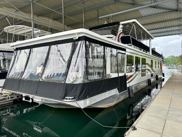 Stardust Cruisers 16x78 2006 Stardust Cruisers 16x78 houseboat docked in a covered marina.