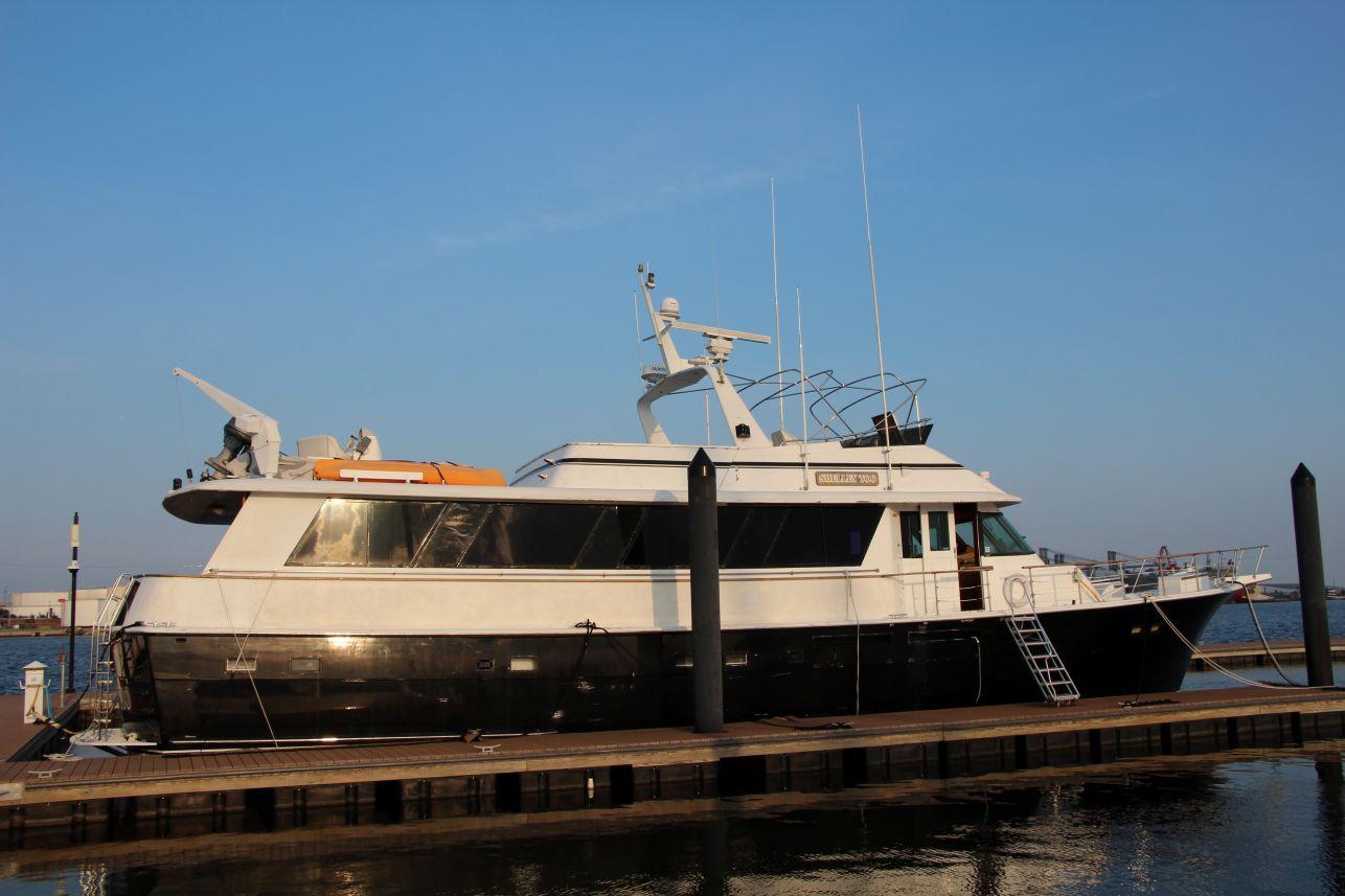 Hatteras 72 Motor Yacht 1985 Hatteras 72 Motor Yacht docked at marina under clear blue sky.