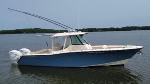 Grady-White Canyon 336 2021 Grady-White Canyon 336 boat on calm water, featuring dual outboard engines.
