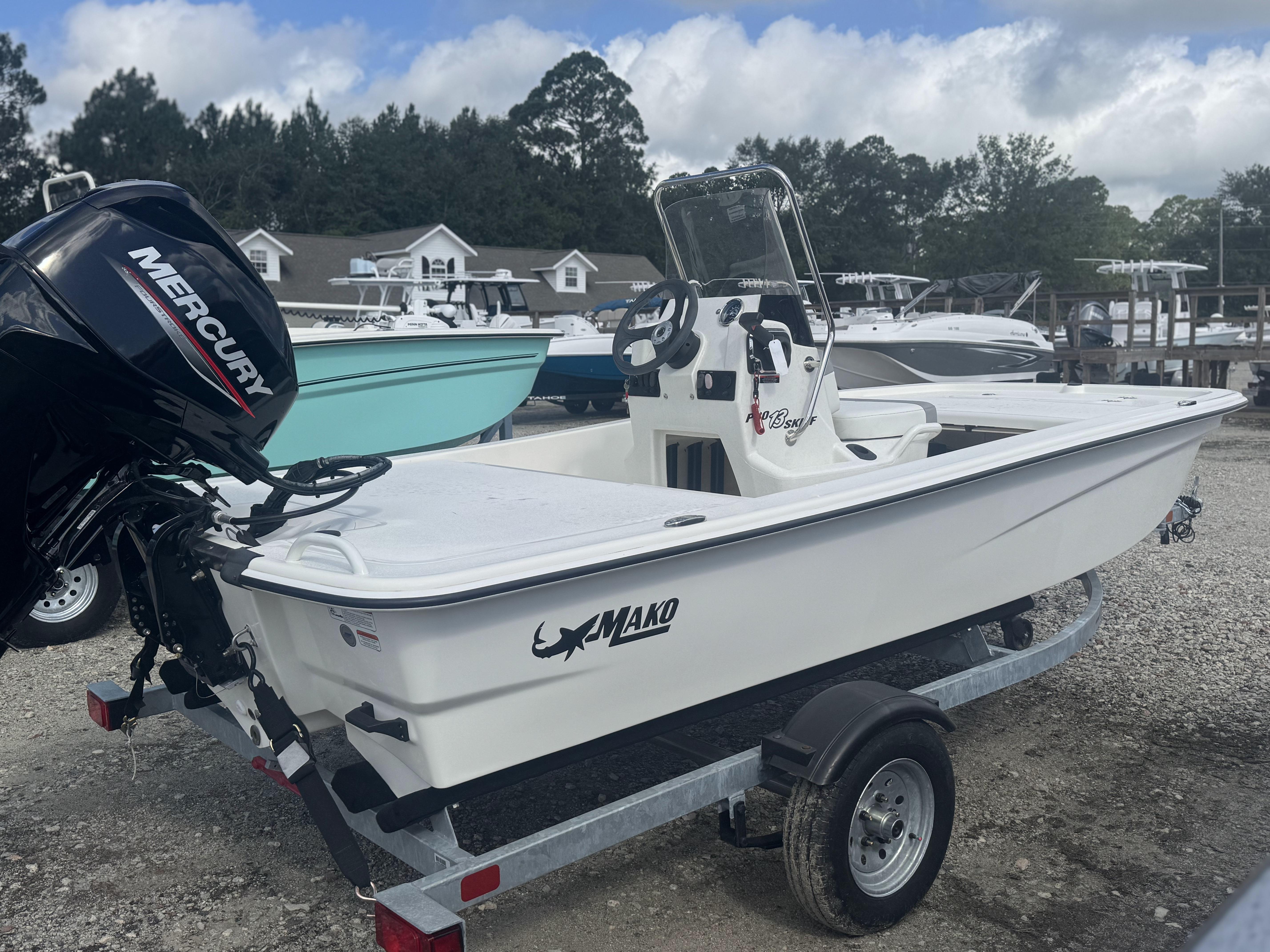 Mako Pro Skiff 13 CC 2024 Mako Pro Skiff 13 CC boat with Mercury engine on trailer, outdoor setting.