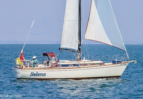 Pearson 323 Pearson 1980 Pearson 323 sailboat "Selene" sailing on calm blue waters.