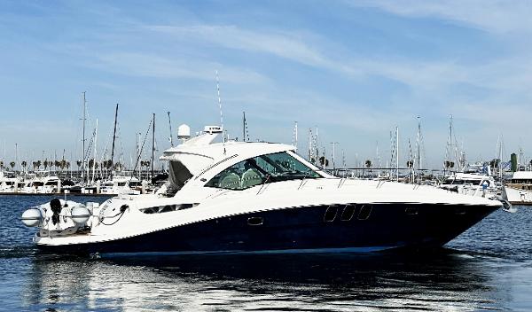 Sea Ray 48 Sundancer 2006 Sea Ray 48 Sundancer yacht on calm water, marina background.