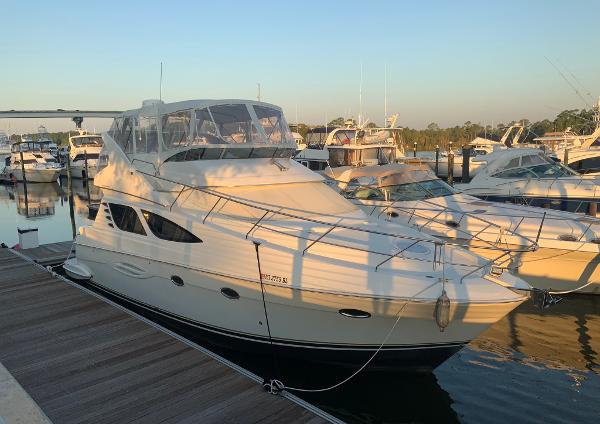 Silverton 43 Sport Bridge 2006 Silverton 43 Sport Bridge yacht docked at marina during sunset.