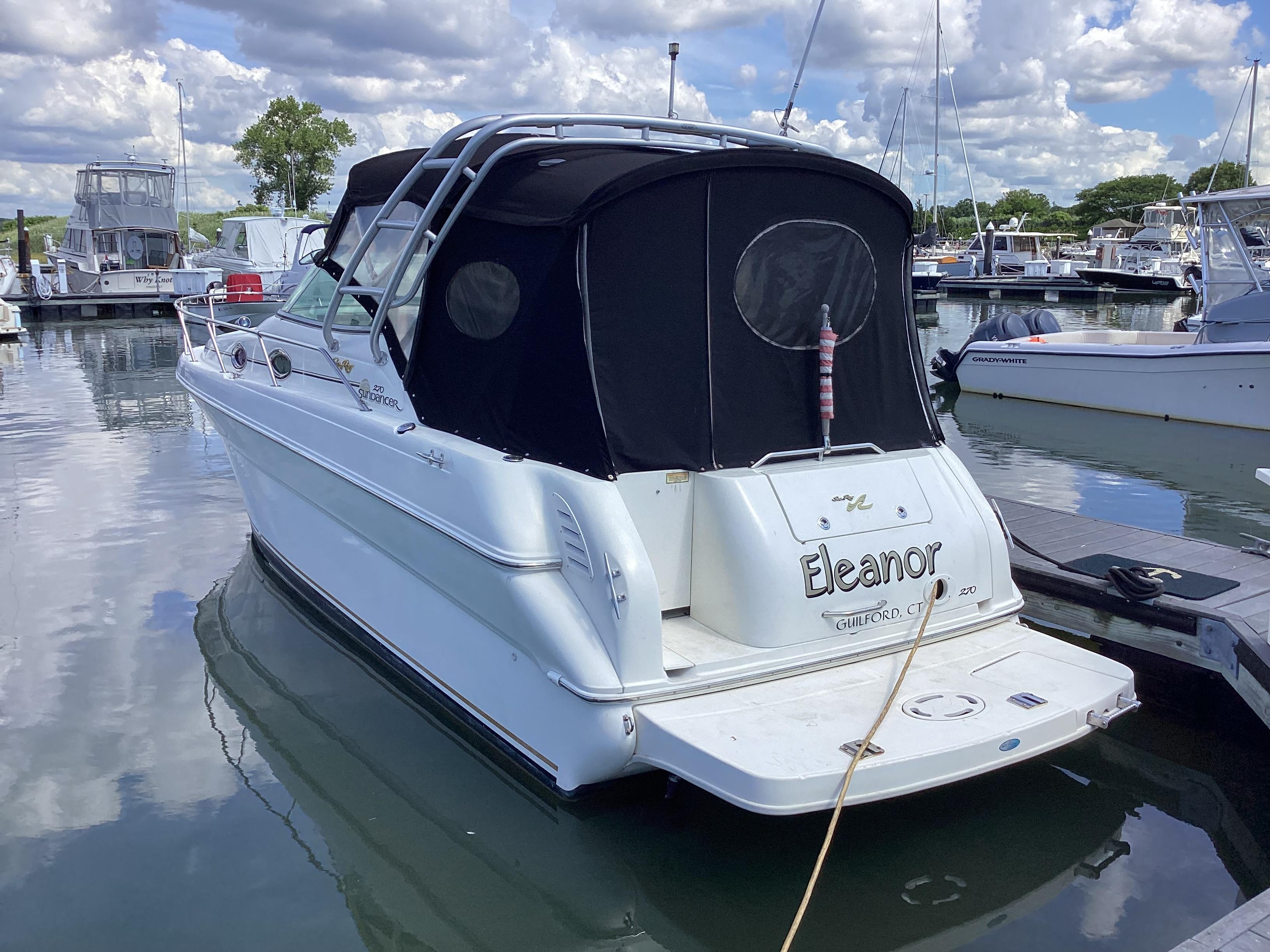 Sea Ray 270 Sundancer 2000 Sea Ray 270 Sundancer boat docked in a marina under cloudy skies.