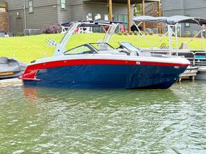 Cobalt R8 Surf 2023 Cobalt R8 Surf boat docked on a calm lake.
