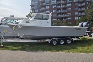 Parker 287 Explorer 2025 Parker 2820 XLD boat on trailer, parked near residential buildings.