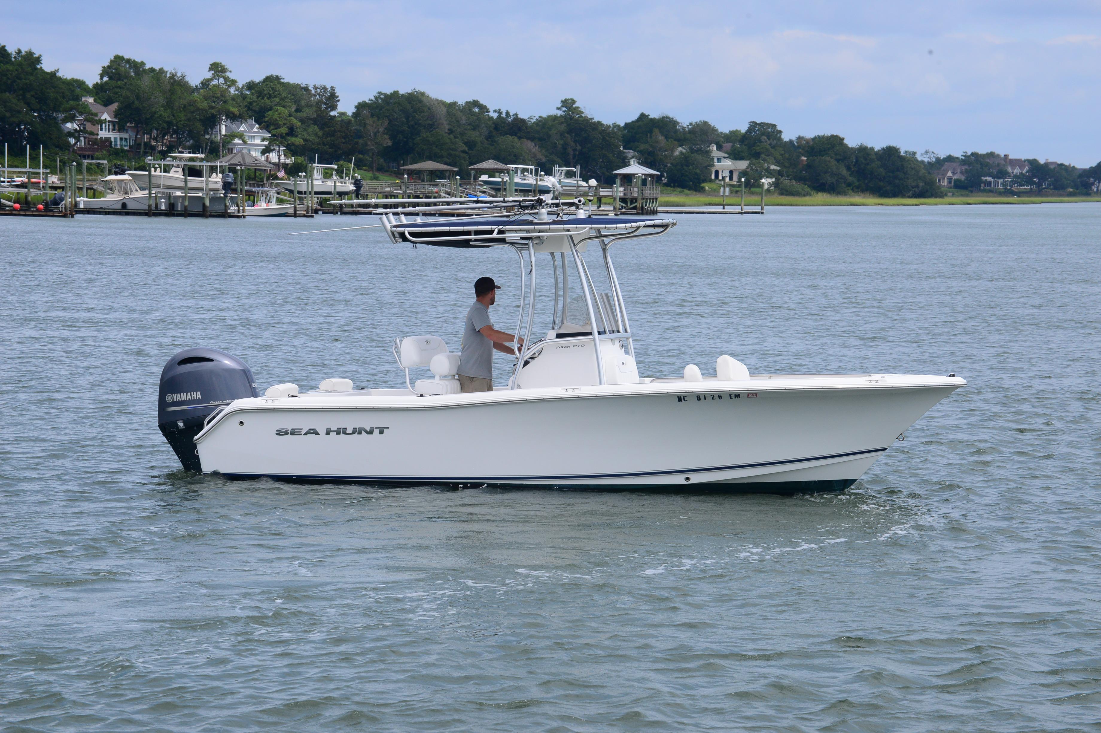 Sea Hunt Triton 210 2015 Sea Hunt Triton 210 boat cruising on a calm waterway.