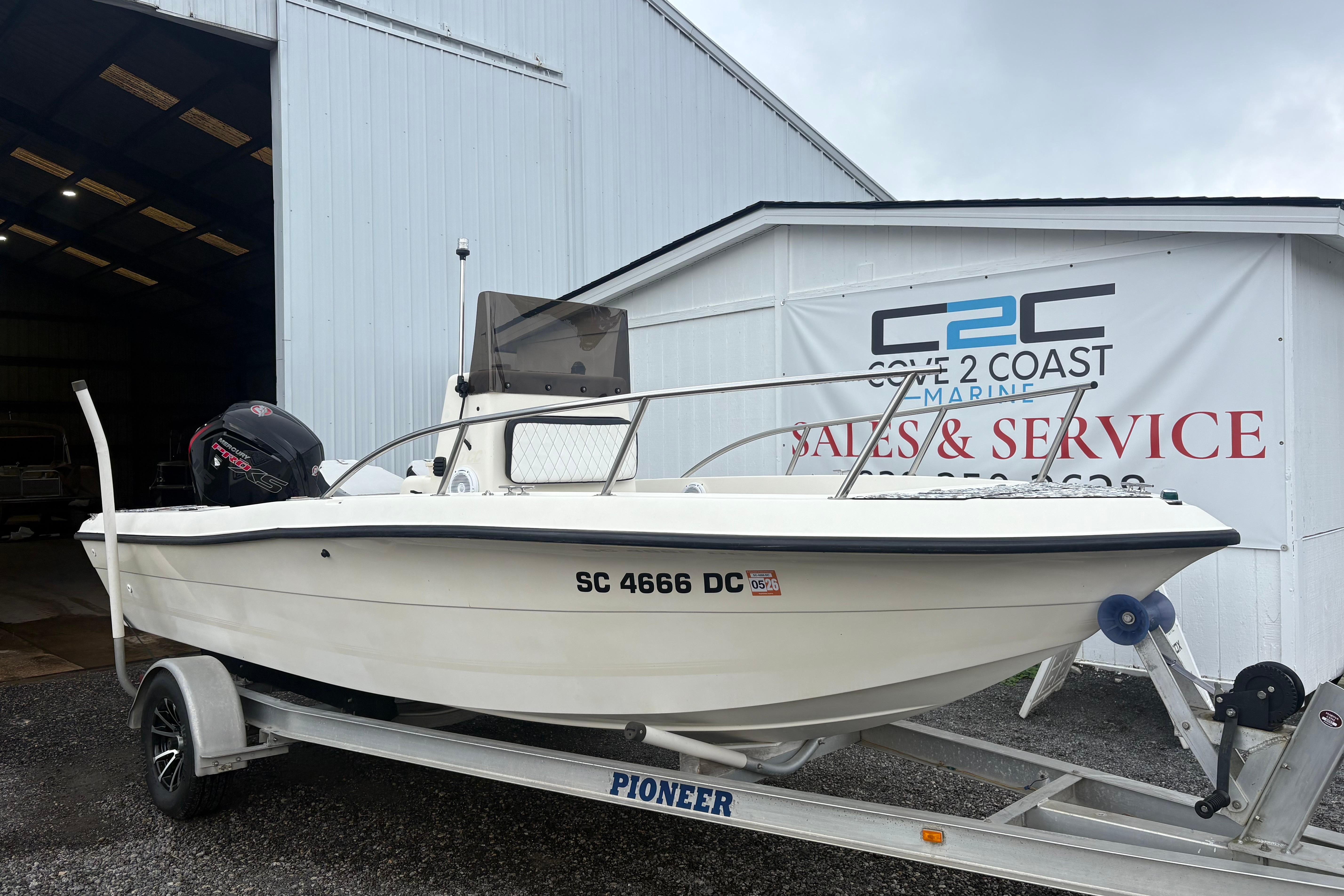 Sea Pro 180 Center Console 1999 Sea Pro 180 Center Console boat on trailer outside marine service building.