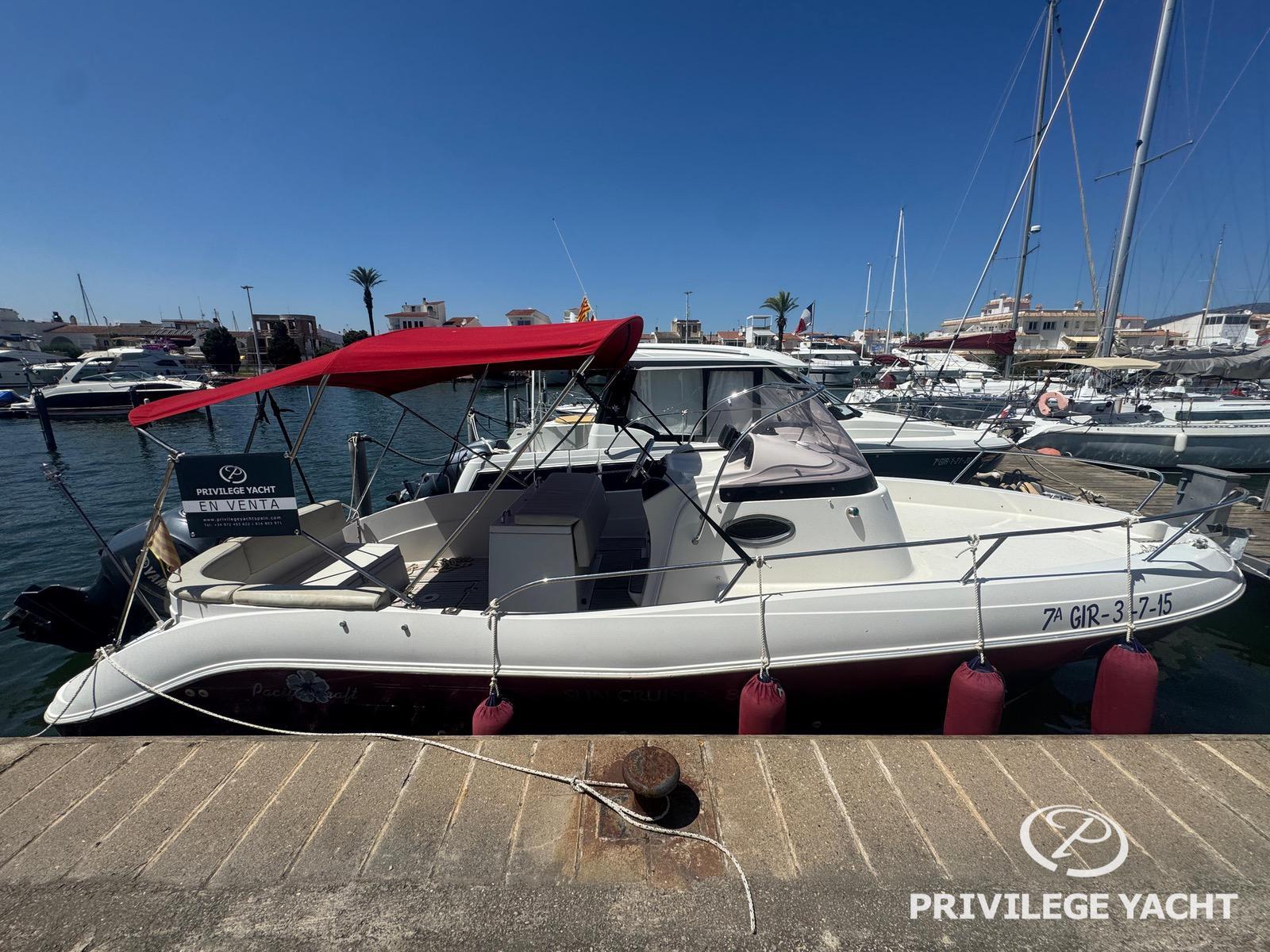 Pacific Craft 805 2008 Pacific Craft 805 yacht with red canopy docked at marina, available for sale.