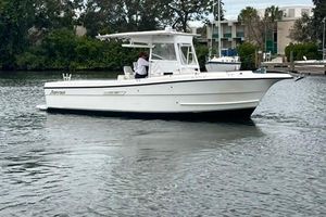 Shamrock 270 Open 2002 Shamrock 270 Open boat on calm water, surrounded by greenery and buildings.