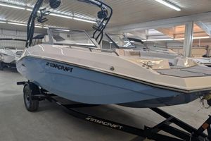 Starcraft SVX 210 IO 2025 Starcraft SVX 210 IO boat in showroom, sleek design on trailer.