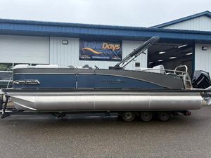 Avalon Catalina Quad Lounger Shift 2025 Avalon Catalina Quad Lounger Shift pontoon boat on trailer outside marine shop.