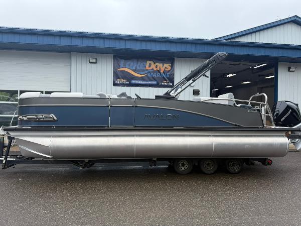 Avalon Catalina Quad Lounger Shift 2025 Avalon Catalina Quad Lounger Shift pontoon boat on trailer outside marine shop.