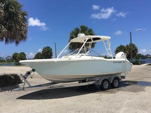 Key West 239 DFS 2016 Key West 239 DFS boat on trailer, parked near palm trees under blue sky.