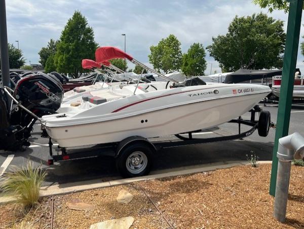 Tahoe T18 2023 Tahoe T18 boat on trailer, parked outdoors with trees in the background.