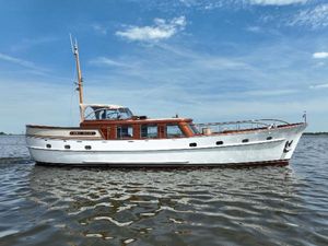 Motor Yacht Lunstroo 56 Classic 1974 Lunstroo 56 motor yacht on calm water under blue sky.