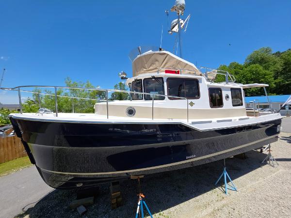 Ranger Tugs R-31 CB 2025 Ranger Tugs R-31 CB boat on stands, blue hull, sunny day.