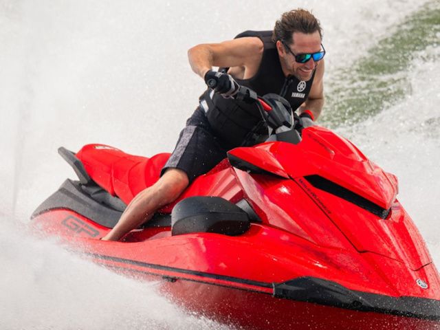 Yamaha WaveRunner GP SVHO With Audio Red 2026 Yamaha WaveRunner GP SVHO with Audio, speeding on water, rider wearing sunglasses.