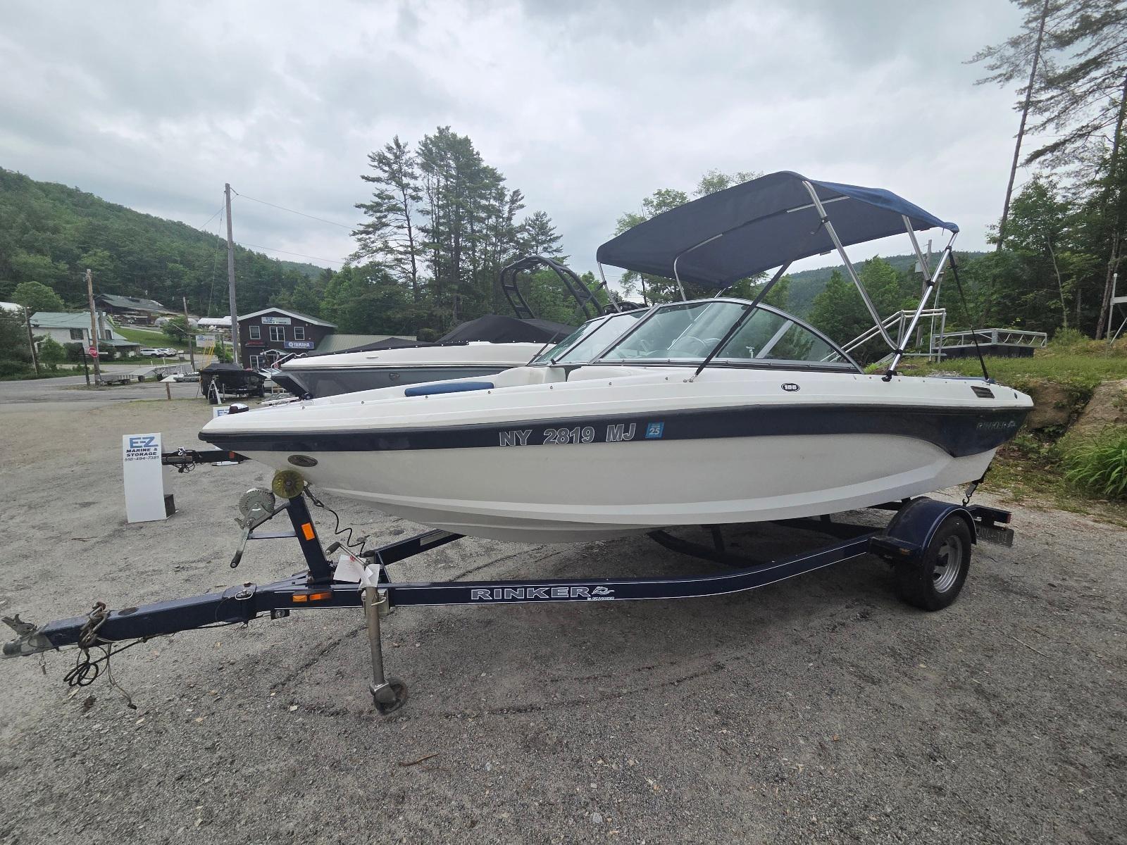 Rinker 186 Captiva 2013 Rinker 186 Captiva boat on trailer, parked outdoors with trees in background.