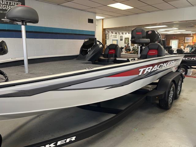 Tracker Savage 215 2025 Tracker Savage 215 boat displayed indoors, featuring sleek design and modern seating.