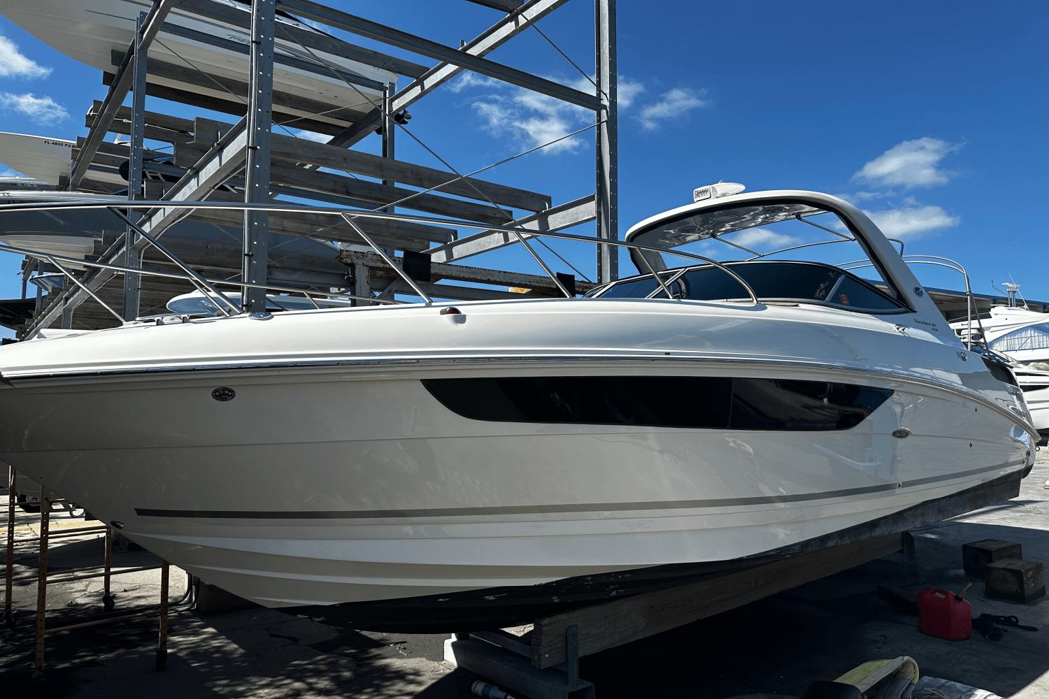 Sea Ray 310 Sundancer 2016 Sea Ray 310 Sundancer boat on dry dock under clear blue sky.