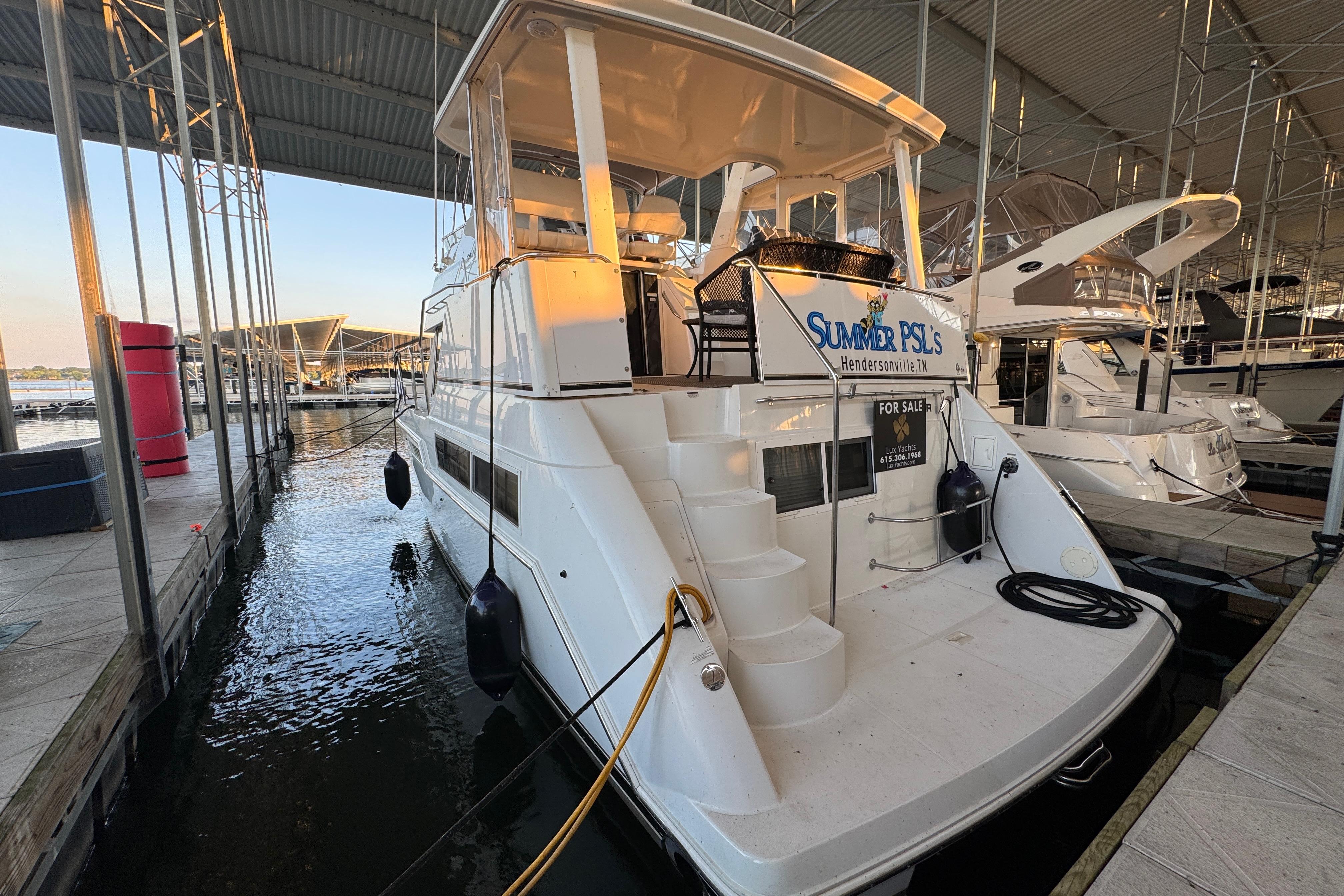 Carver 356 Aft Cabin 1998 Carver 356 Aft Cabin yacht docked, for sale, in marina setting.
