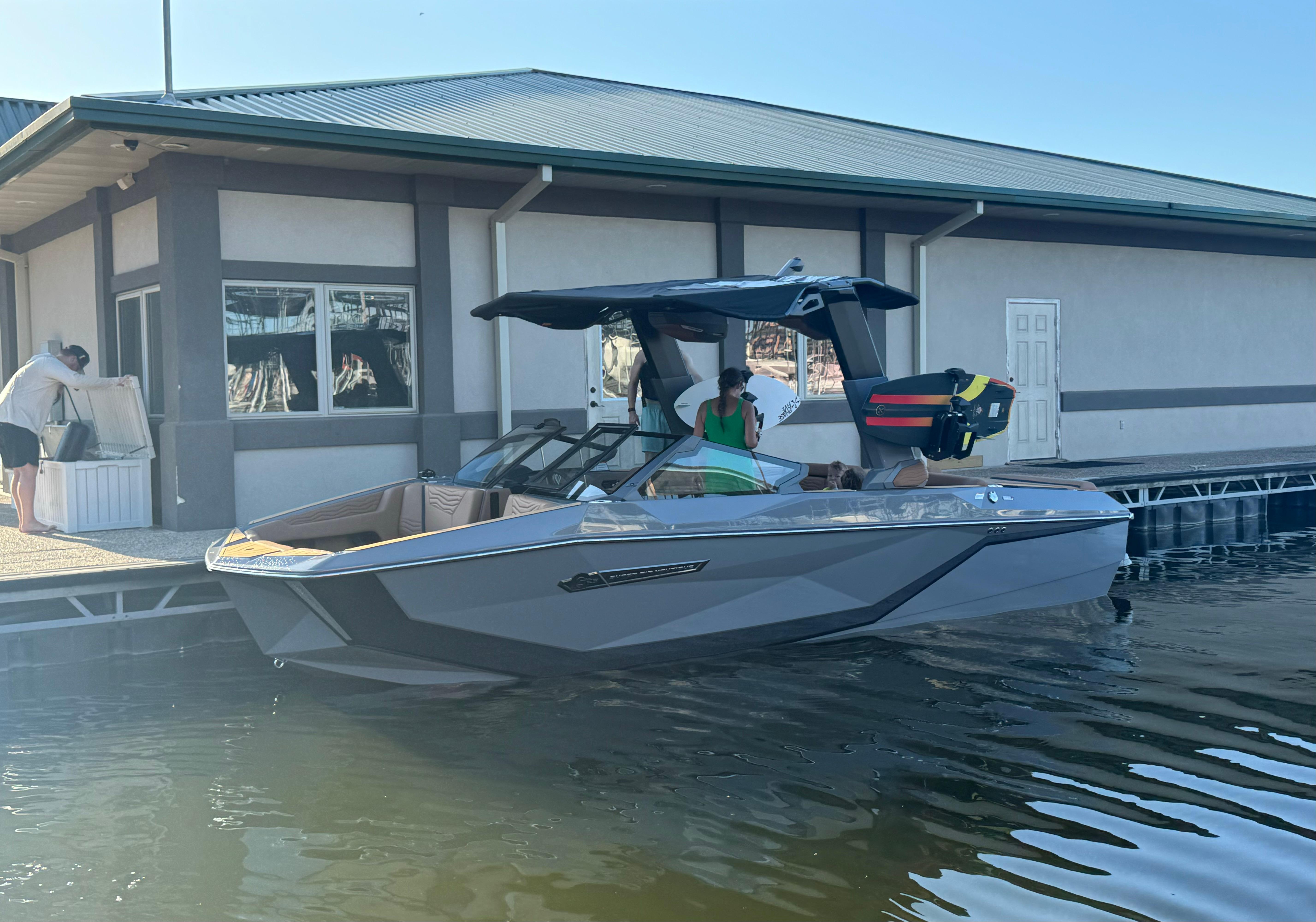 Nautique Super Air Nautique G23 2025 Nautique Super Air Nautique G23 boat docked beside a building.