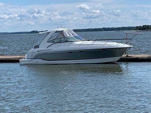 Formula 34 Performance Cruiser 2007 Formula 34 PC boat docked on a calm lake under a partly cloudy sky.