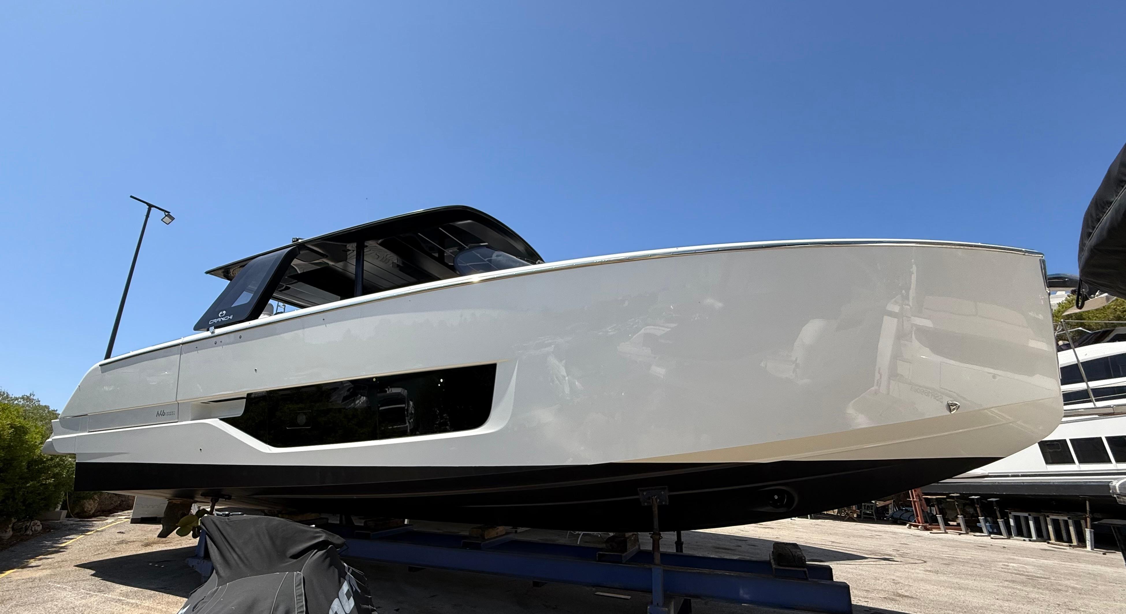 Cranchi A46 Luxury Tender 2022 Cranchi A46 Luxury Tender yacht on display under clear blue sky.