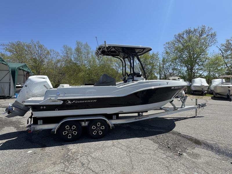 Finseeker 230 CC 2022 Finseeker 230 CC boat on trailer, parked outdoors under clear blue sky.
