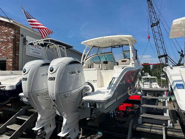 Pursuit DC 266 Dual Console 2025 Pursuit DC 266 Dual Console boat with twin Yamaha engines, displayed outdoors.