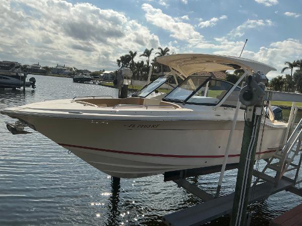 Scout 255 Dorado 2019 Scout 255 Dorado boat on lift, sunny day, waterfront view.