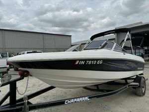 Chaparral 180 SSi 2007 Chaparral 180 SSi boat on trailer, parked outdoors under cloudy skies.