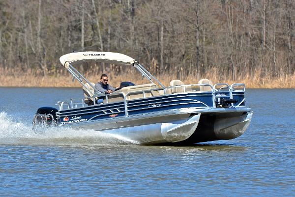Sun Tracker Fishin' Barge 20 DLX 2023 Sun Tracker Fishin Barge 20 DLX cruising on a lake.