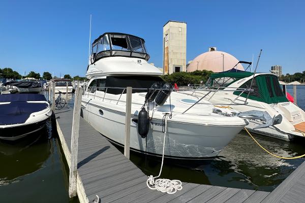 Meridian 341 Sedan 2003 Meridian 341 Sedan yacht docked at marina under clear blue sky.