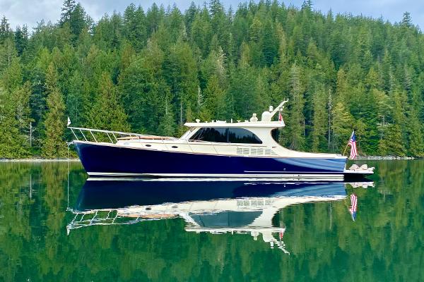 Hinckley Talaria 48 MY MKII Hinckley Talaria 48 MY MKII yacht on calm water, surrounded by lush forest, 2020 model.