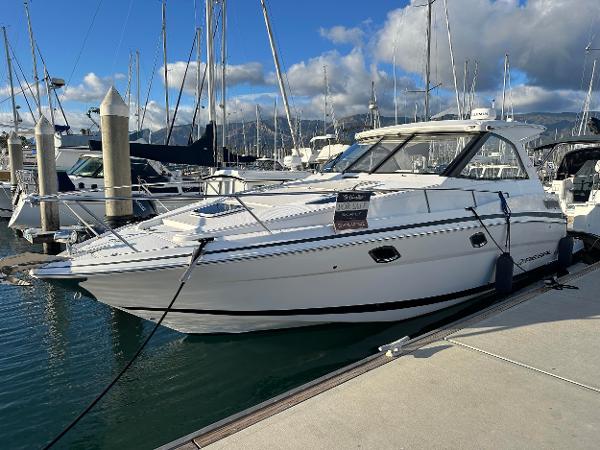Regal Sport Coupe 2016 Regal Sport Coupe boat docked at marina under blue sky.