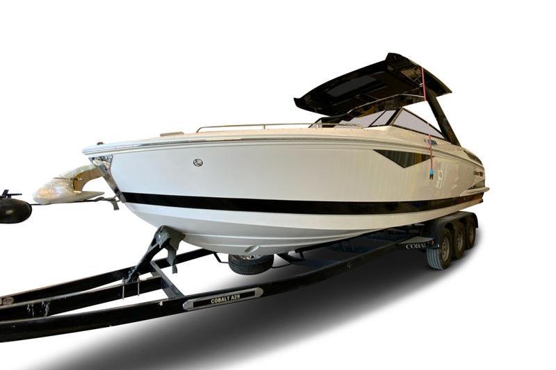 Cobalt A29 2026 Cobalt A29 boat on trailer, sleek design, white hull, black accents.