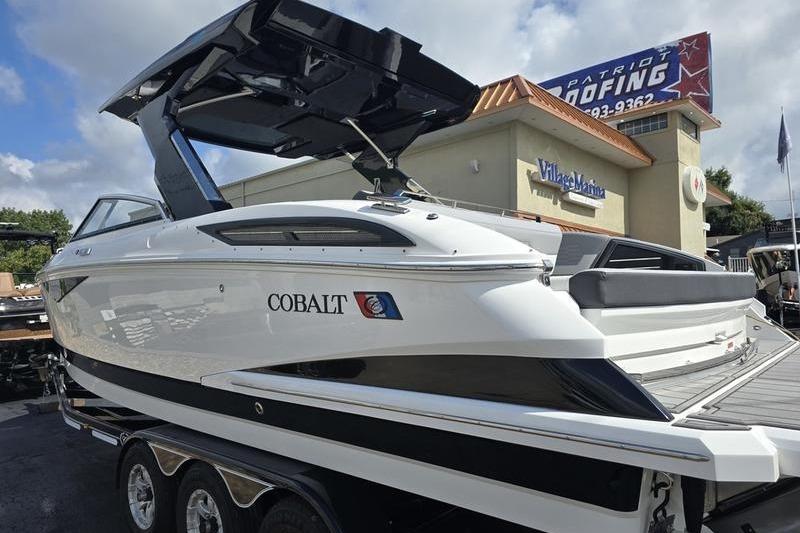 Cobalt A29 2026 Cobalt A29 boat displayed at a dealership under a clear sky.