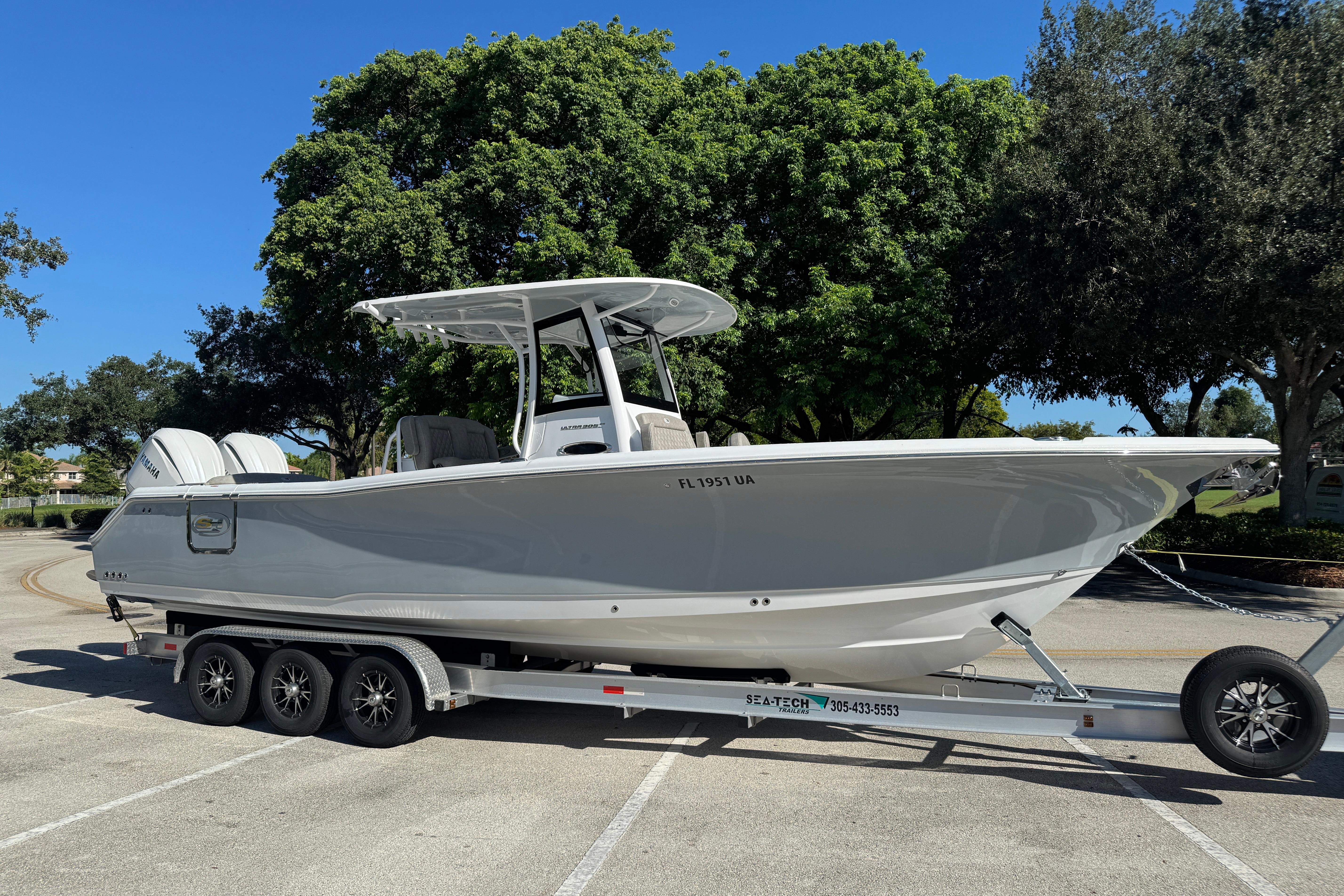 Sea Hunt Ultra 305 SE 2025 Sea Hunt Ultra 305 SE boat on trailer, parked outdoors under clear blue sky.